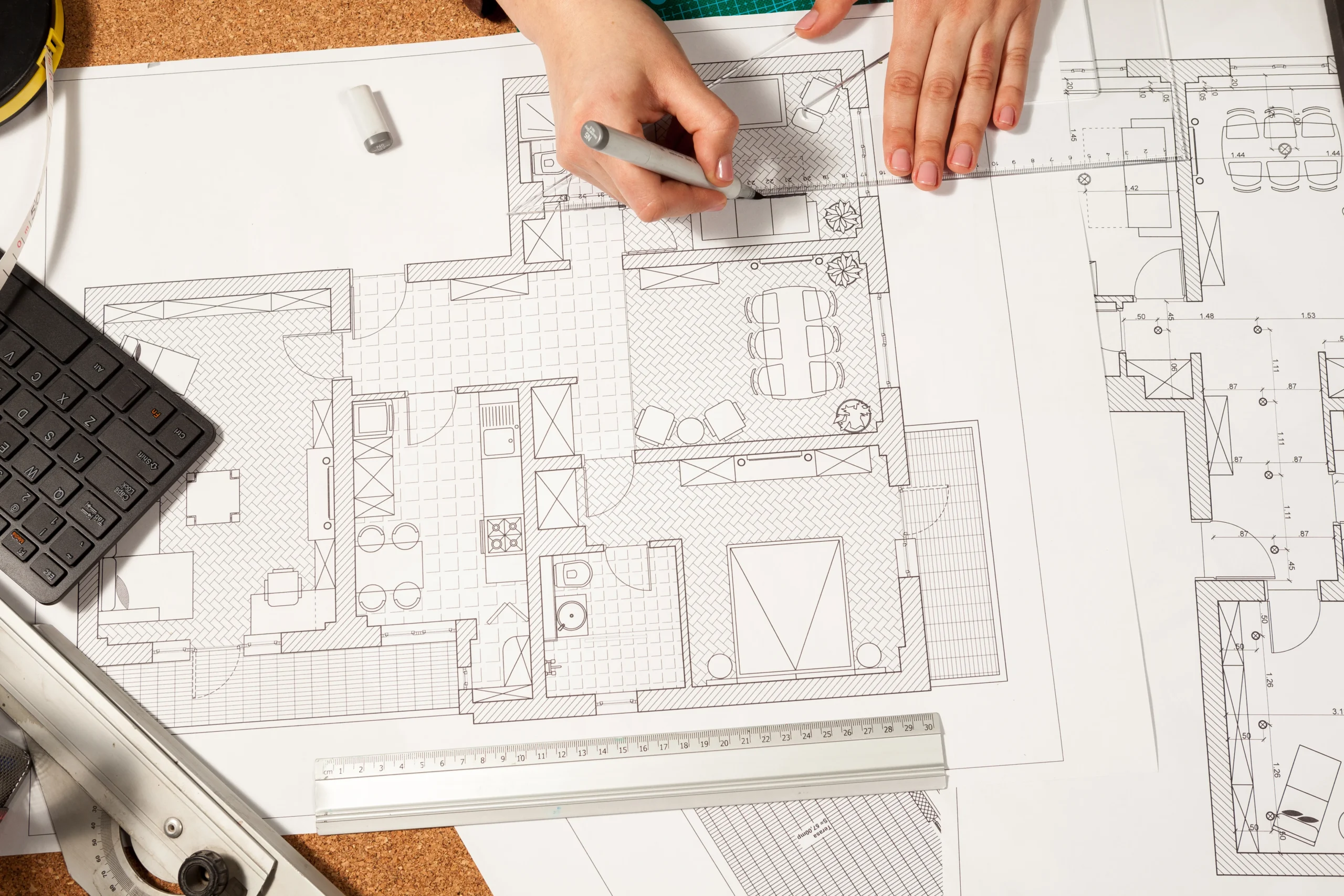 close-up-of-hands-working-on-blueprints-on-table-2026-01-08-02-20-47-utc